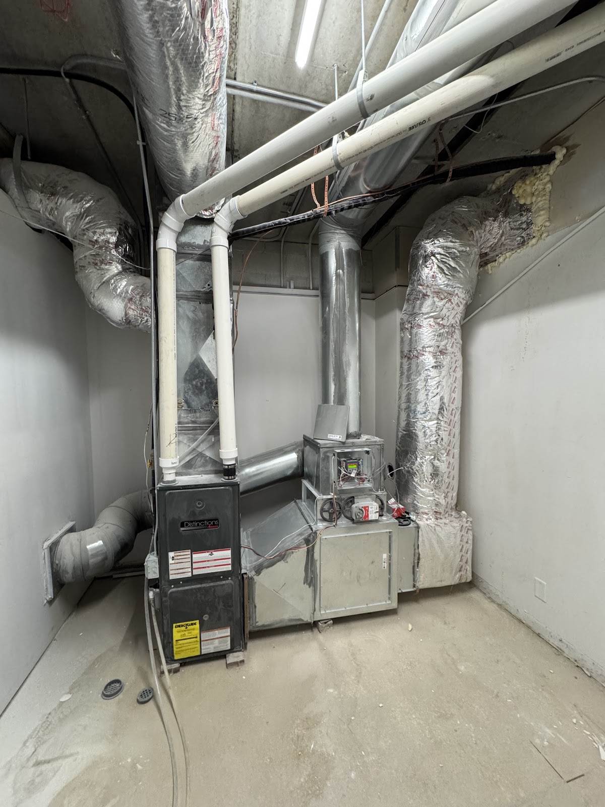 New furnace and ductwork installed in a utility room