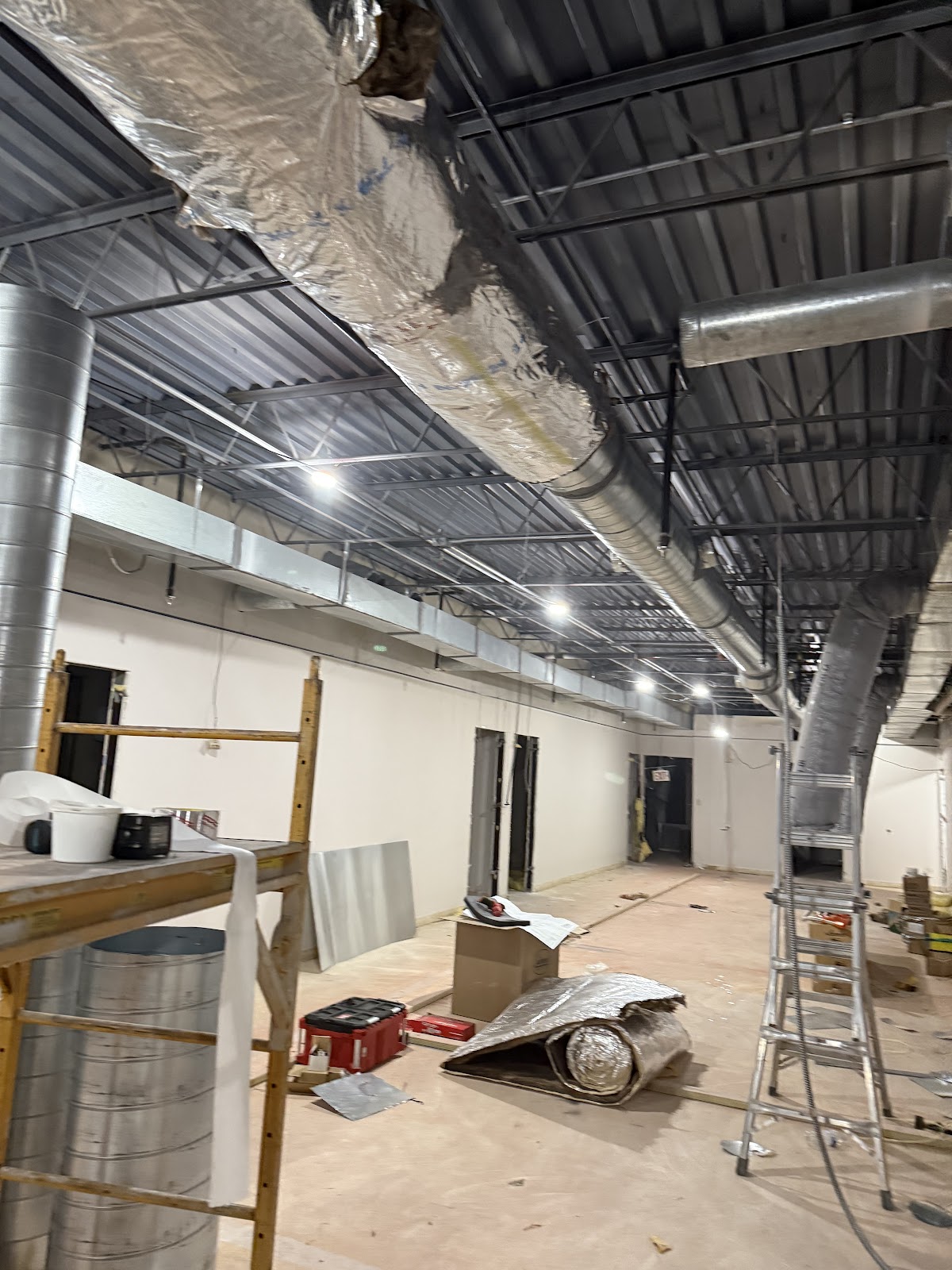 New overhead ductwork run through a commercial build out
