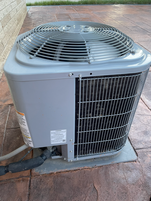 Outdoor AC condenser on a stamped patio
